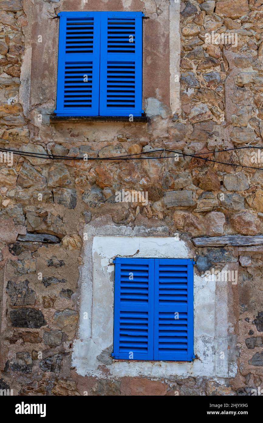 Vertical shot of an old building with blue wooden windows Stock Photo ...