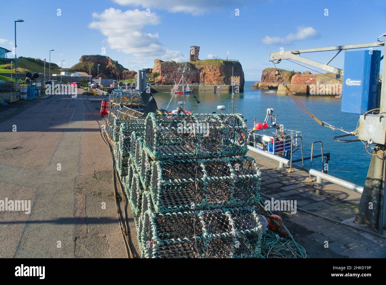Looking west over Dunbar Harbour to ancient historic Castle ruins. Beautiful clear day.   East Lothian, Scotland, UK Stock Photo