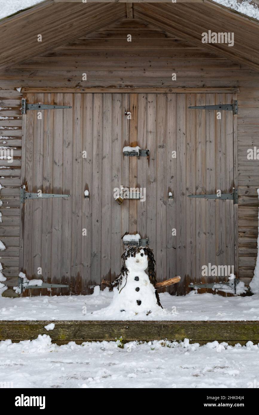 A snowman on a beach hut porch at Westgate-on-Sea, Margate, Kent, UK Stock Photo