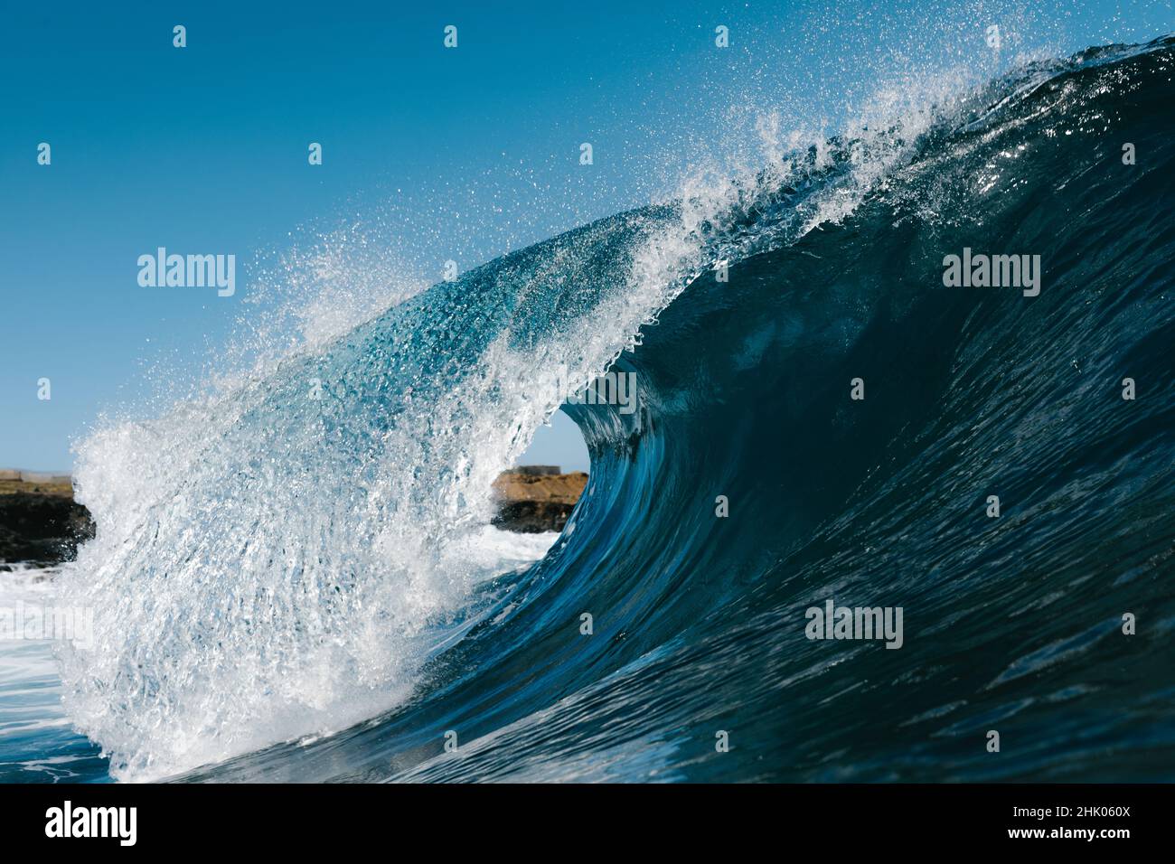 Blue wave breaking on a surfing beach in Canary Islands Stock Photo