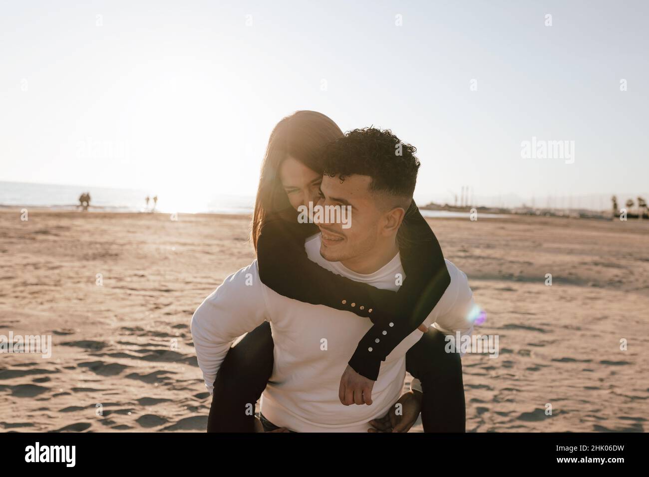 Girl hugging on her boyfriend's back Stock Photo