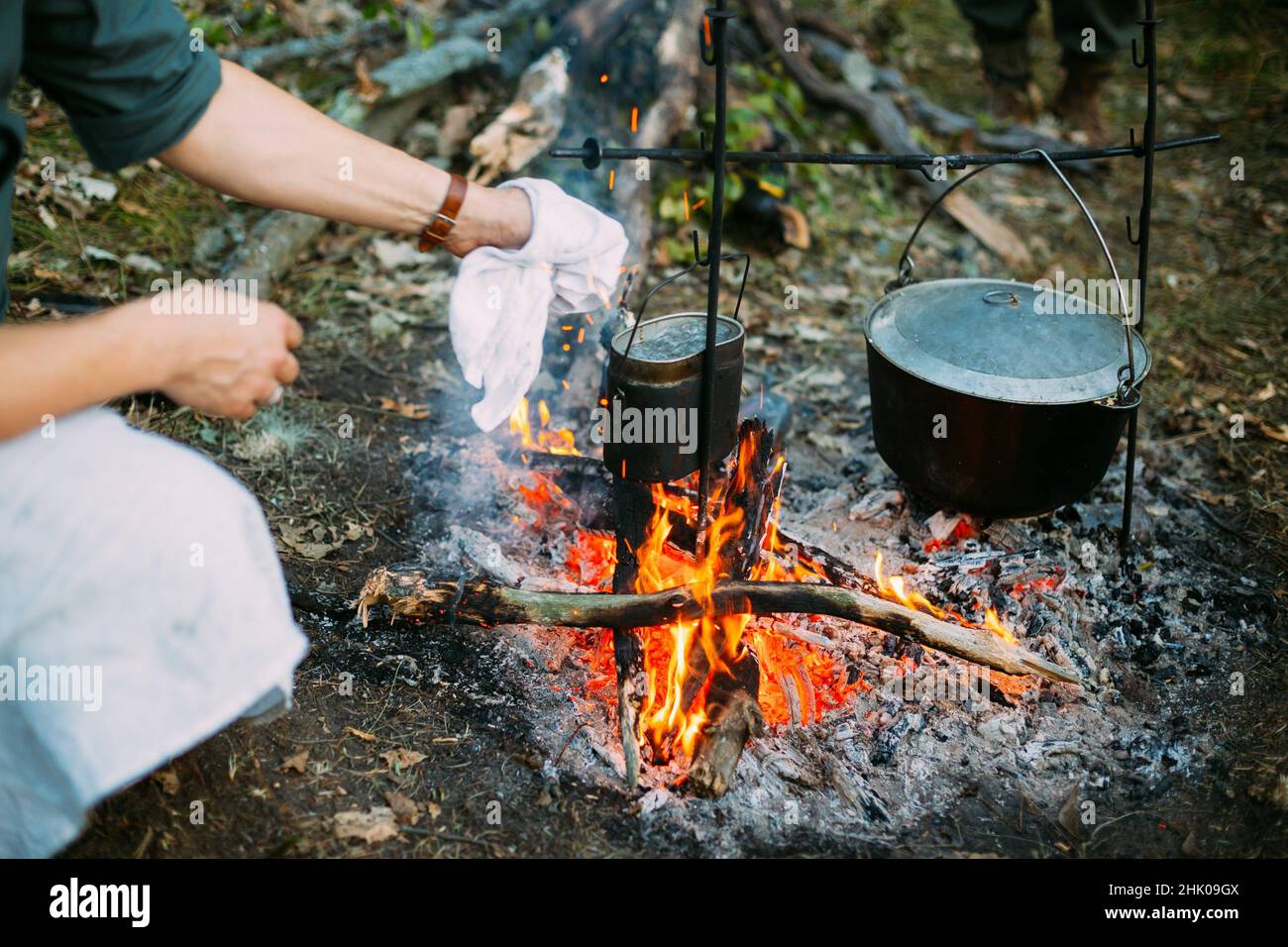 Food Is Cooked Over A Fire In An Old Marching Pot. Stock Photo