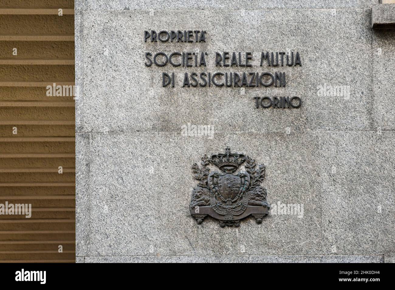 Detail of the old sign of Società Reale Mutua di Assicurazioni, a mutual insurance company founded in Turin in 1828, on a building exterior, Piedmont Stock Photo