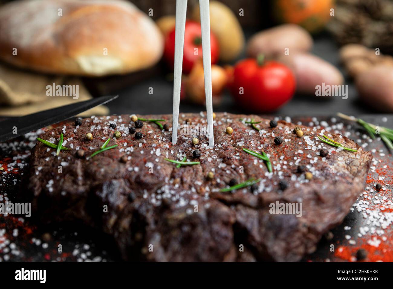 Beef steak seasoned with salt, pepper and fresh hearbs searved in the