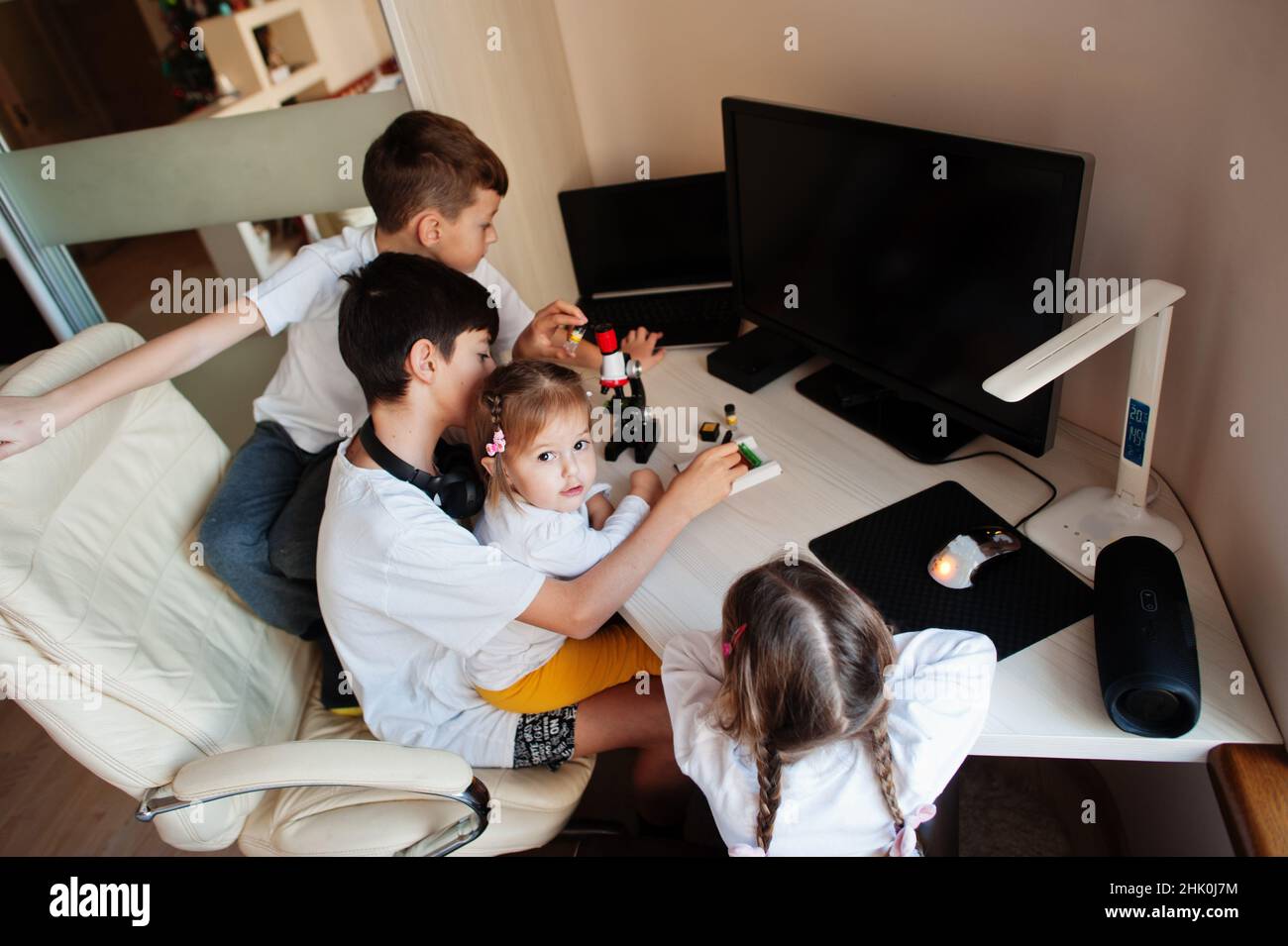 Kids using microscope learning science class at home Stock Photo - Alamy