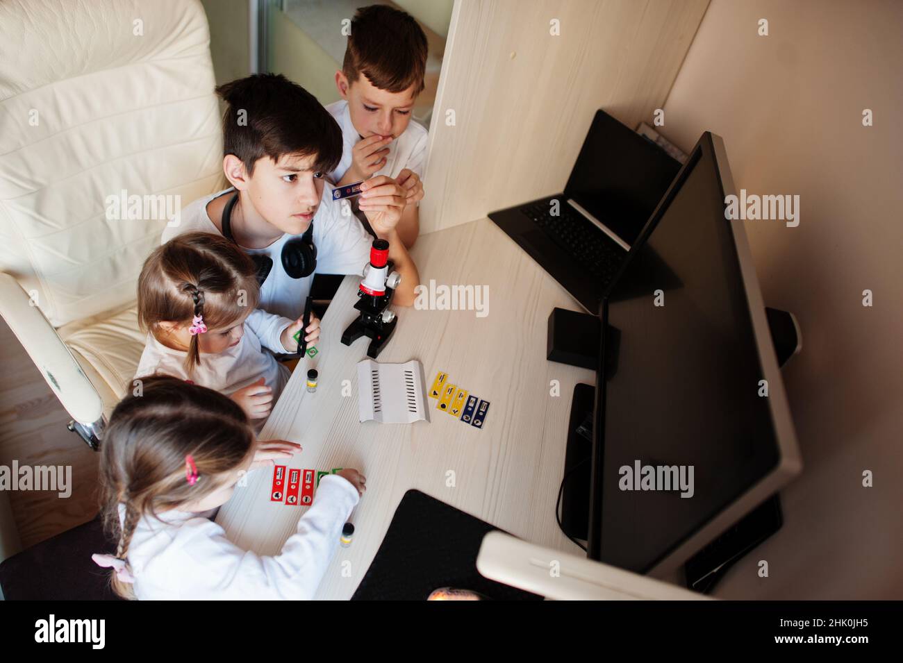 Kids using microscope learning science class at home Stock Photo - Alamy