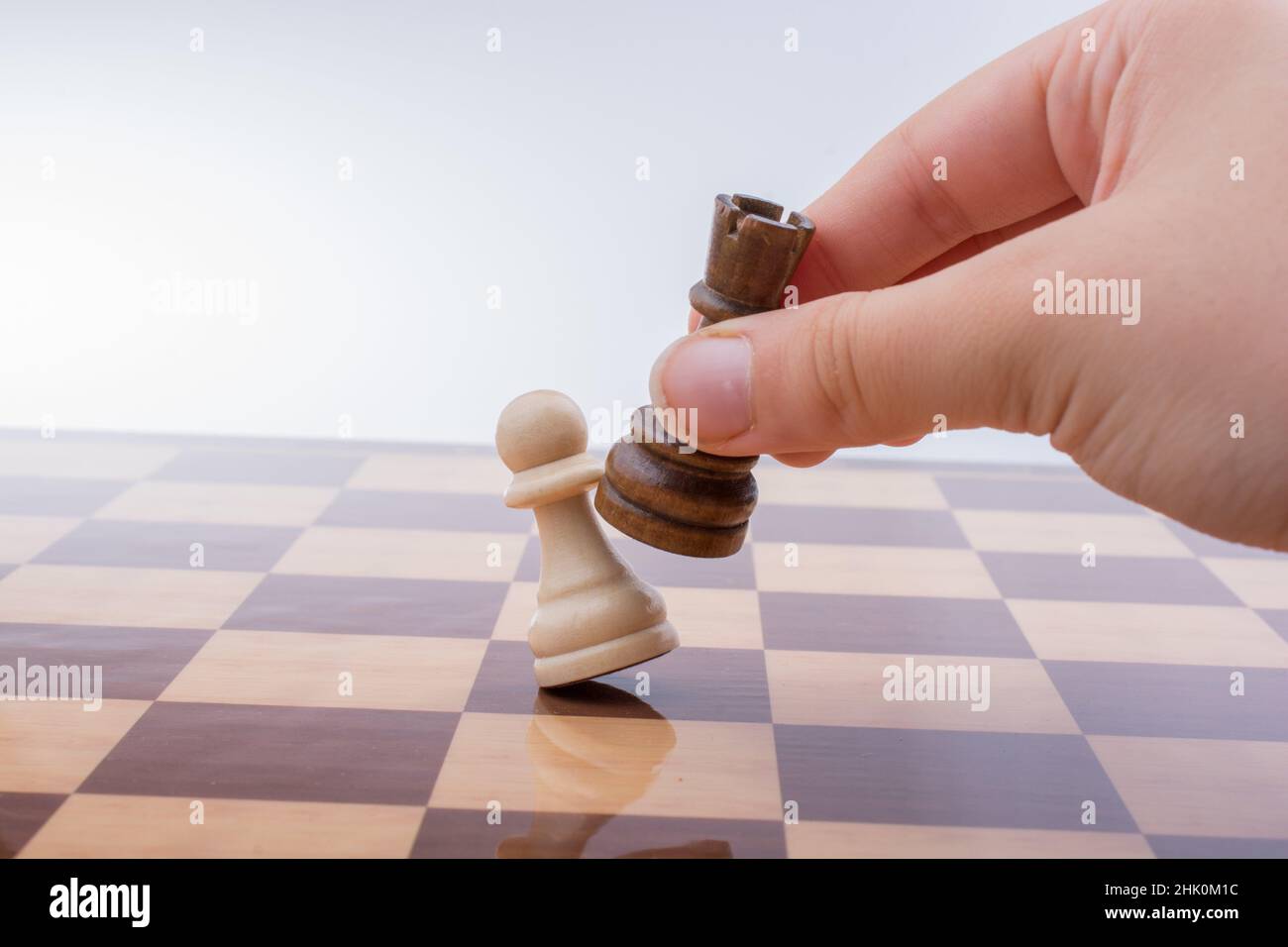 Premium Photo  Person playing chess board game, conceptual image of  businesswoman holding chess pieces against opponent chess against business  competition, planning business strategies to defeat business competitors