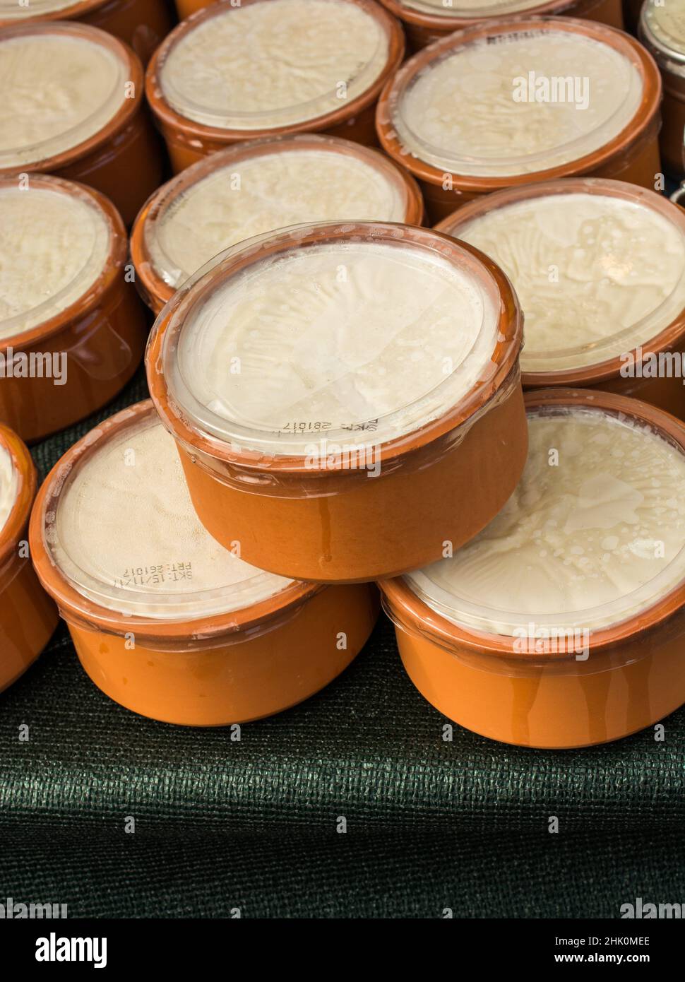 Kaymak, a creamy dairy product similar to cream, made from milk, in clay pots. Stock Photo