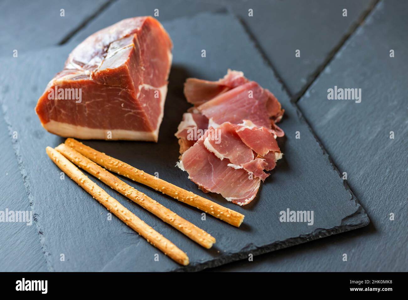 Italian ham served with grissini Stock Photo Alamy