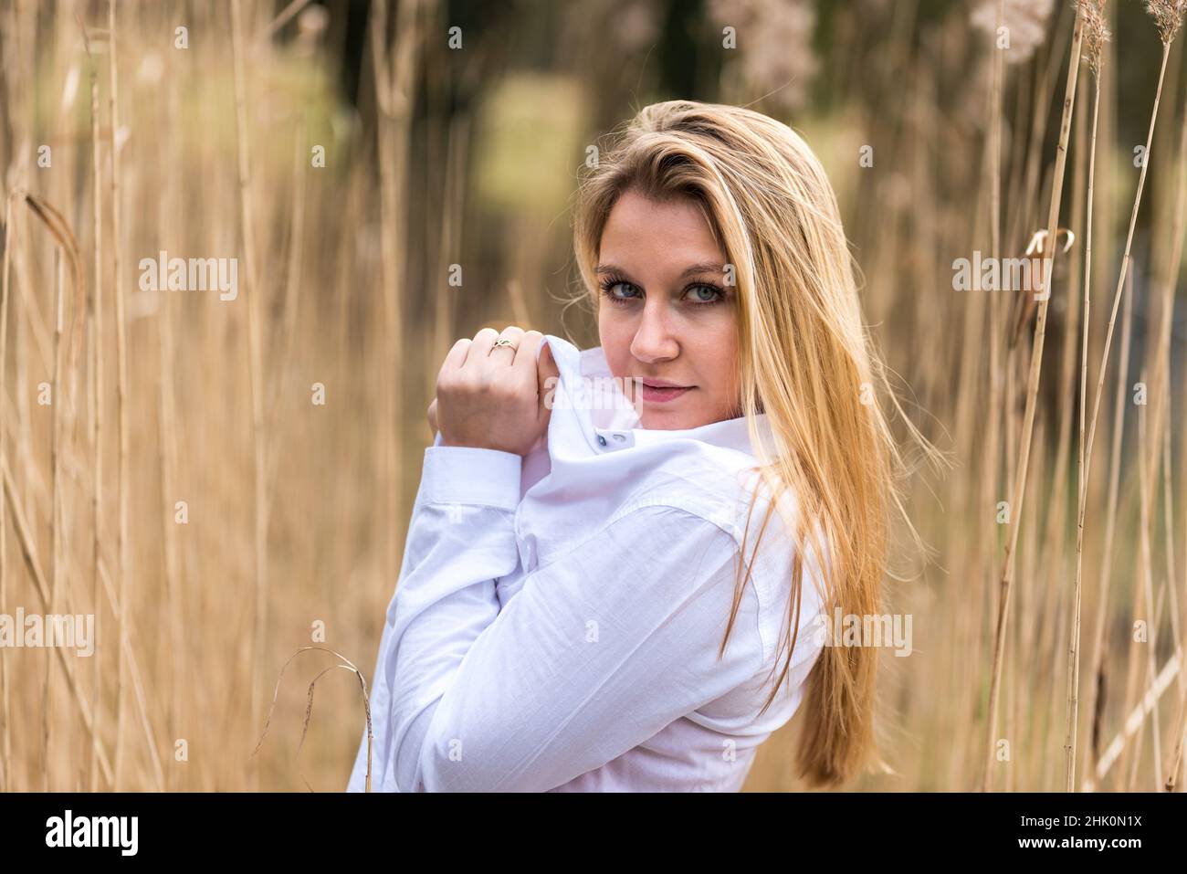 Jette, Brussels, Belgium, 03 14 2018: White model with long sleek blonde hair posingin a nature park. Stock Photo