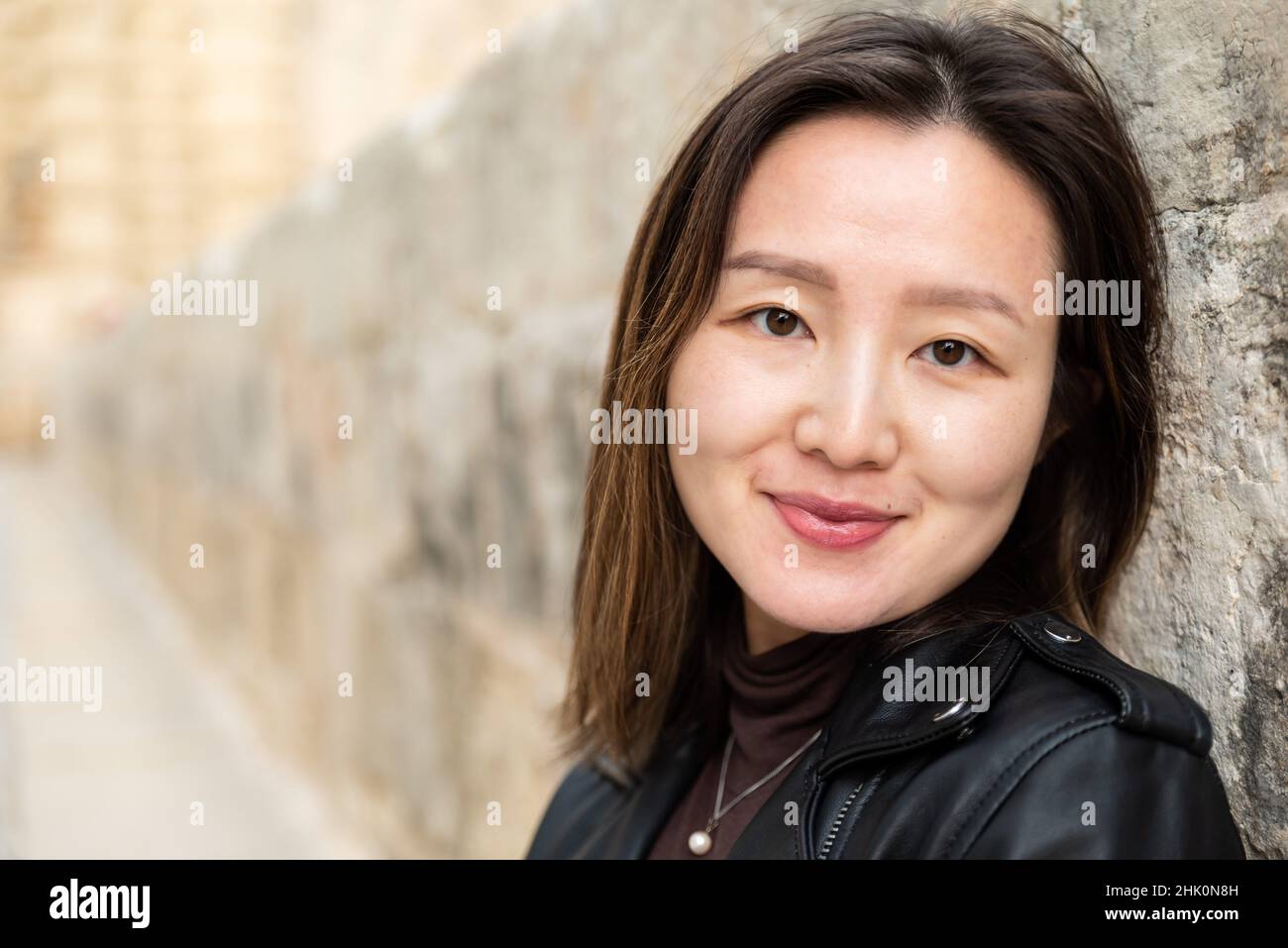 Head shot portrait of an attractive 29 year old Asian American girl