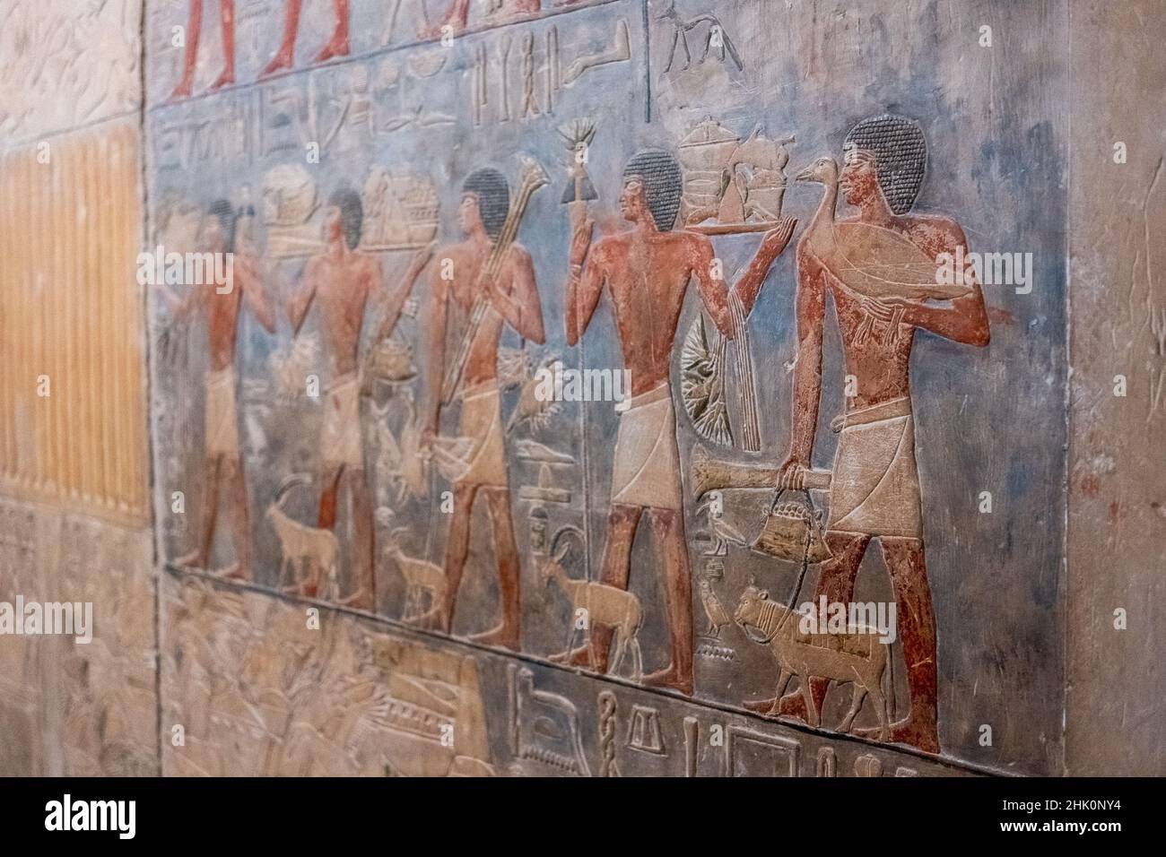 Cairo Egypt January 2022 Hieroglyph fresceos of people doing things on the walls of a tomb inside a pyramid in egypt Stock Photo
