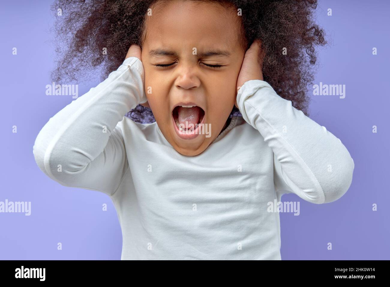 Photo of young child girl unhappy close ears irritated stressed problem