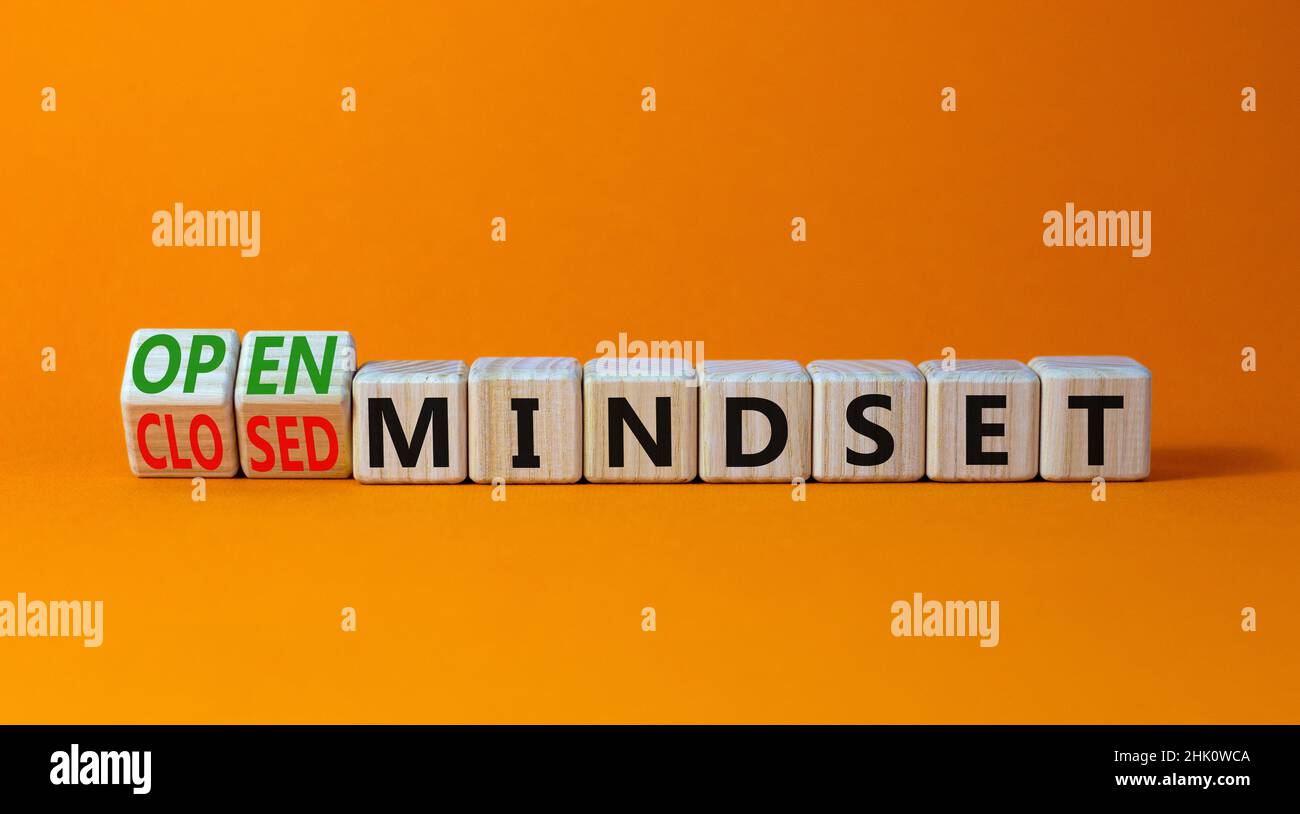 Open or closed mindset symbol. Turned wooden cubes and changed concept words closed mindset to open mindset. Beautiful orange background, copy space. Stock Photo