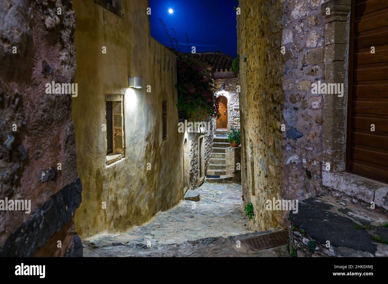 Beautiful Alley in Medieval Castle Town of Monemvasia Island, Greece at Night. Picturesque Street with Stone Houses from Byzantine Era. Stock Photo
