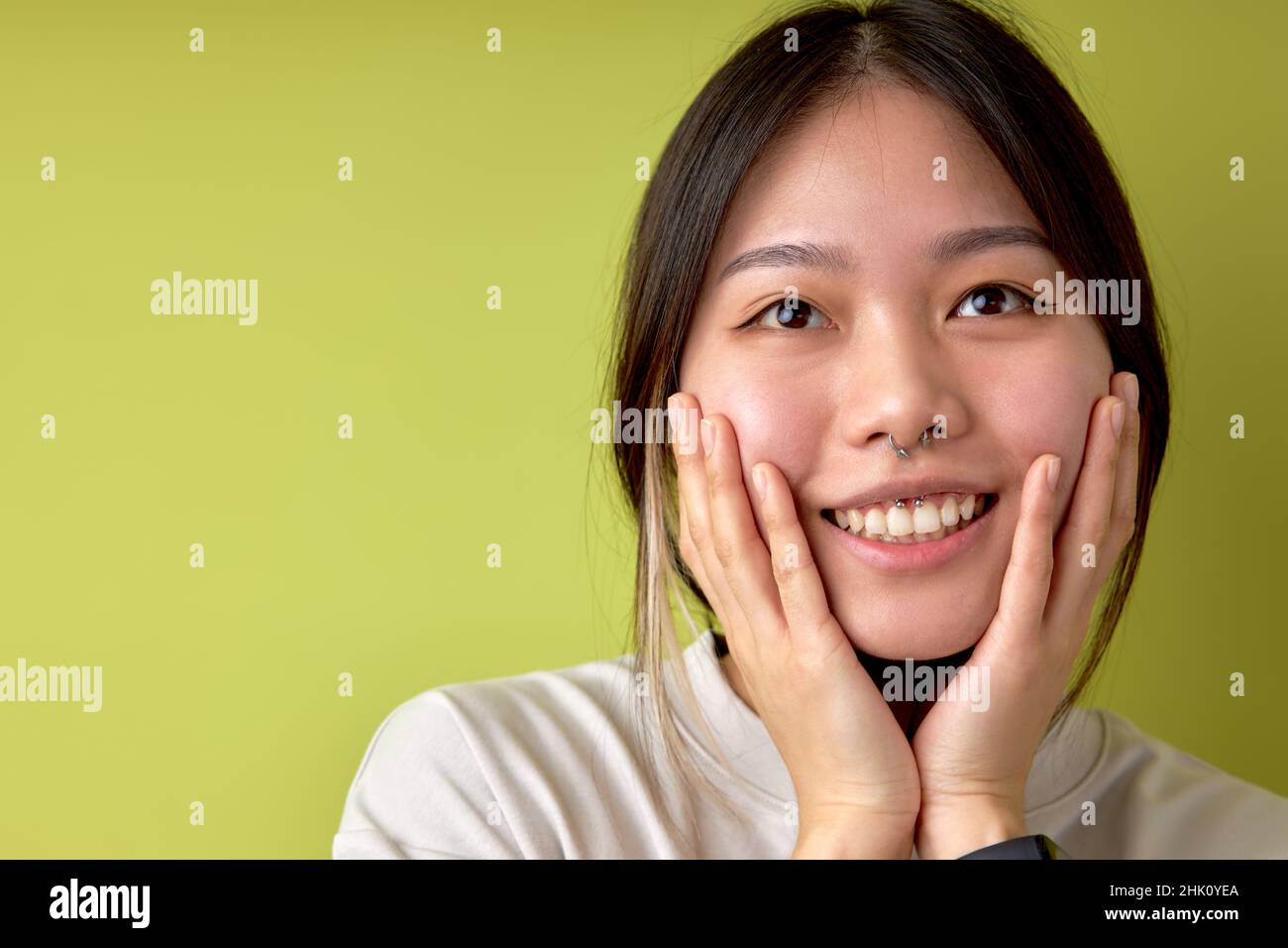 Asian women hand touch cheek looking on something with shocked and