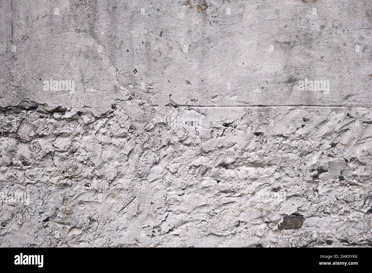Old traditional white limewash plastered stonework wall Stock Photo