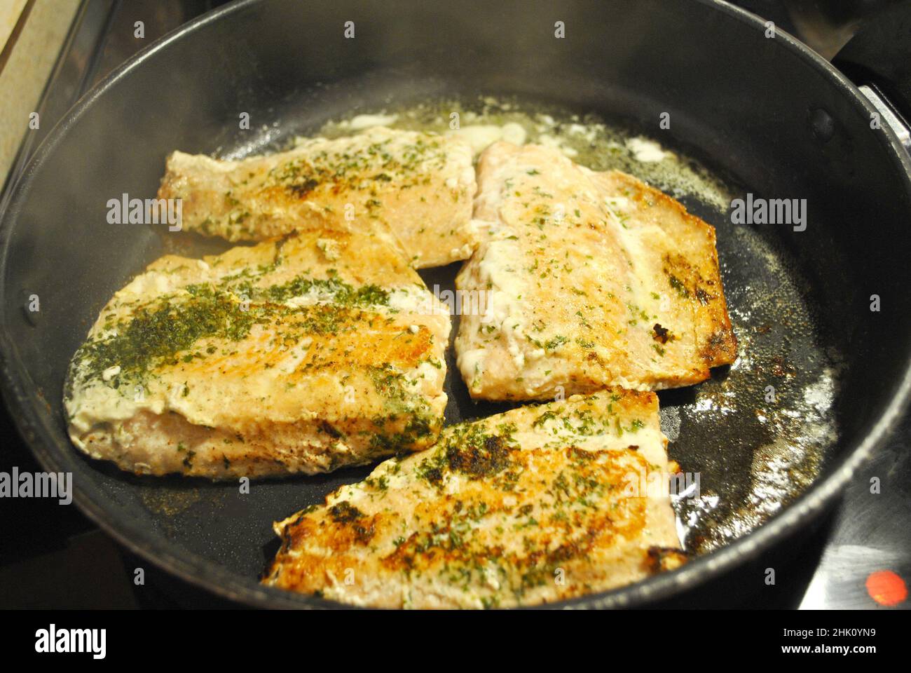 Salmon Frying with Butter and Parsley Stock Photo Alamy