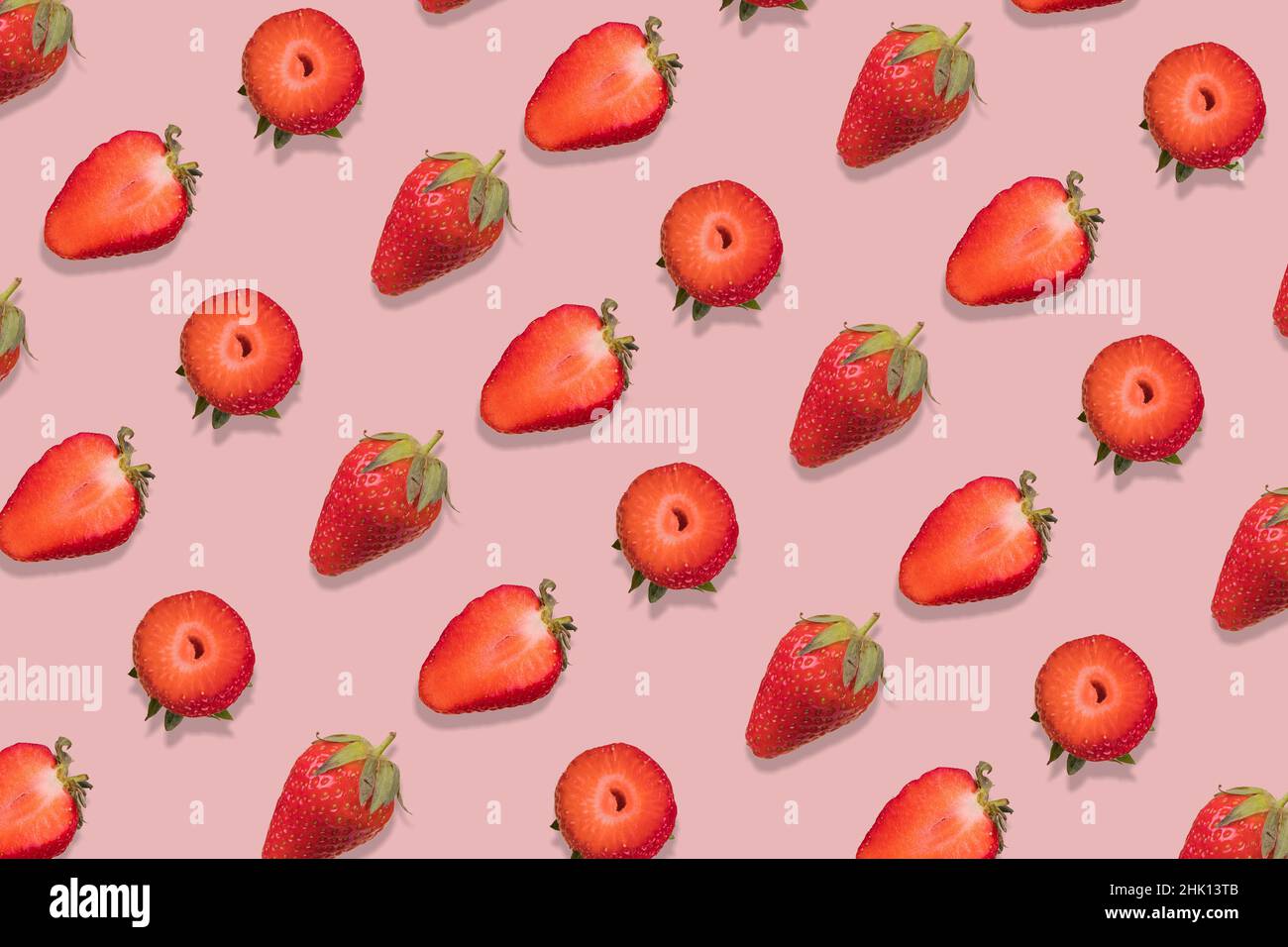Strawberry pattern on a pastel pink background, creative flat lay healthy food concept, top view. Stock Photo