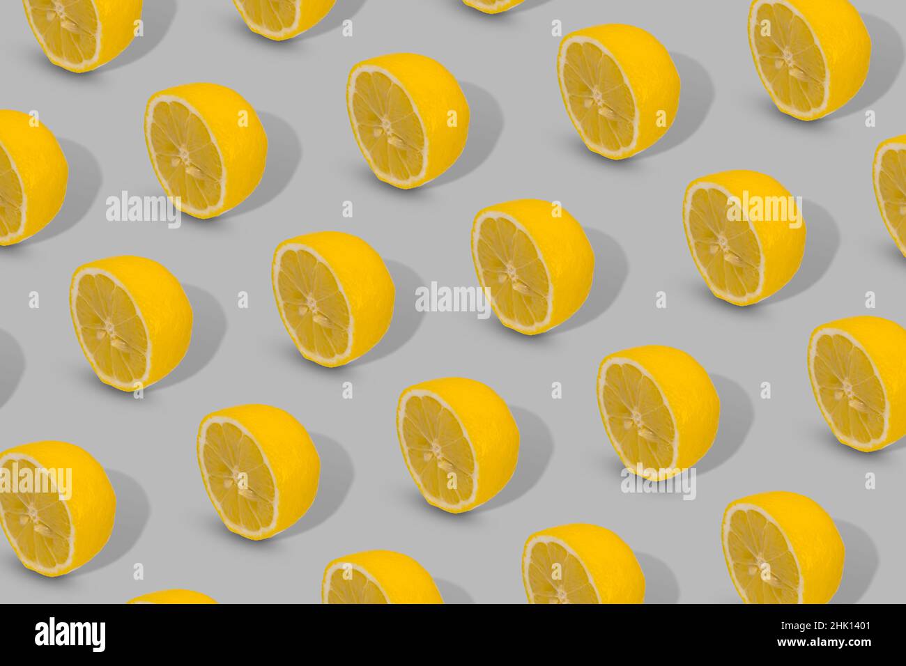 Trendy Summer pattern made with yellow lemon slice on a gray background. Minimal summer concept. Stock Photo