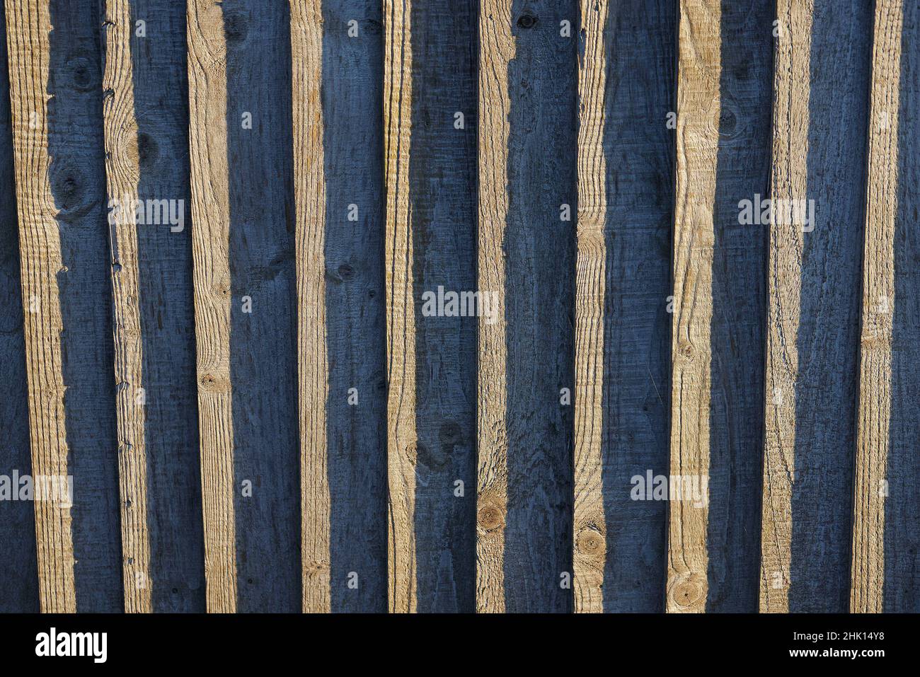 Close up of a wooden garden fence panel with abstract and contrasting vertical lines and shapes. Stock Photo