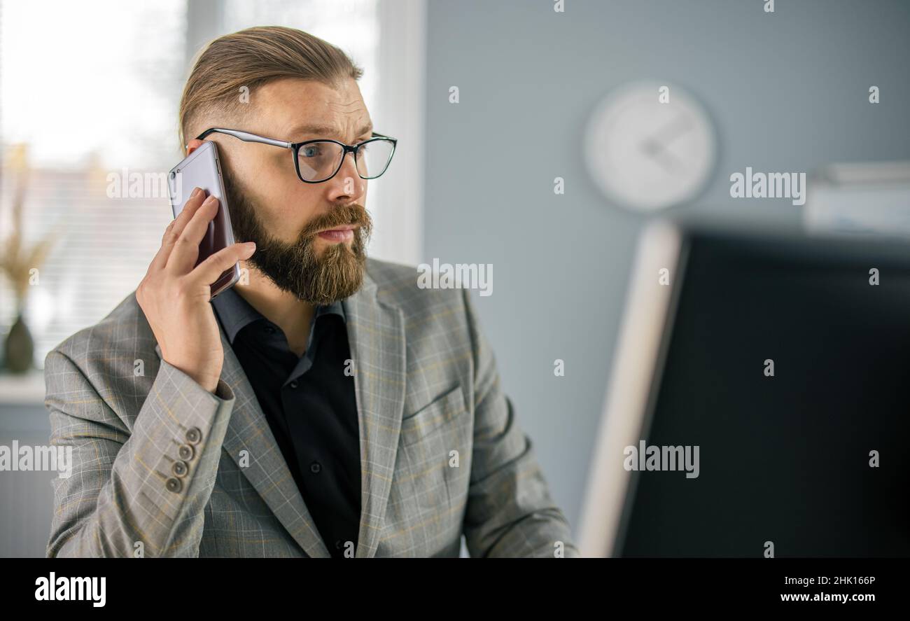 Man talking on mobile at office Stock Photo