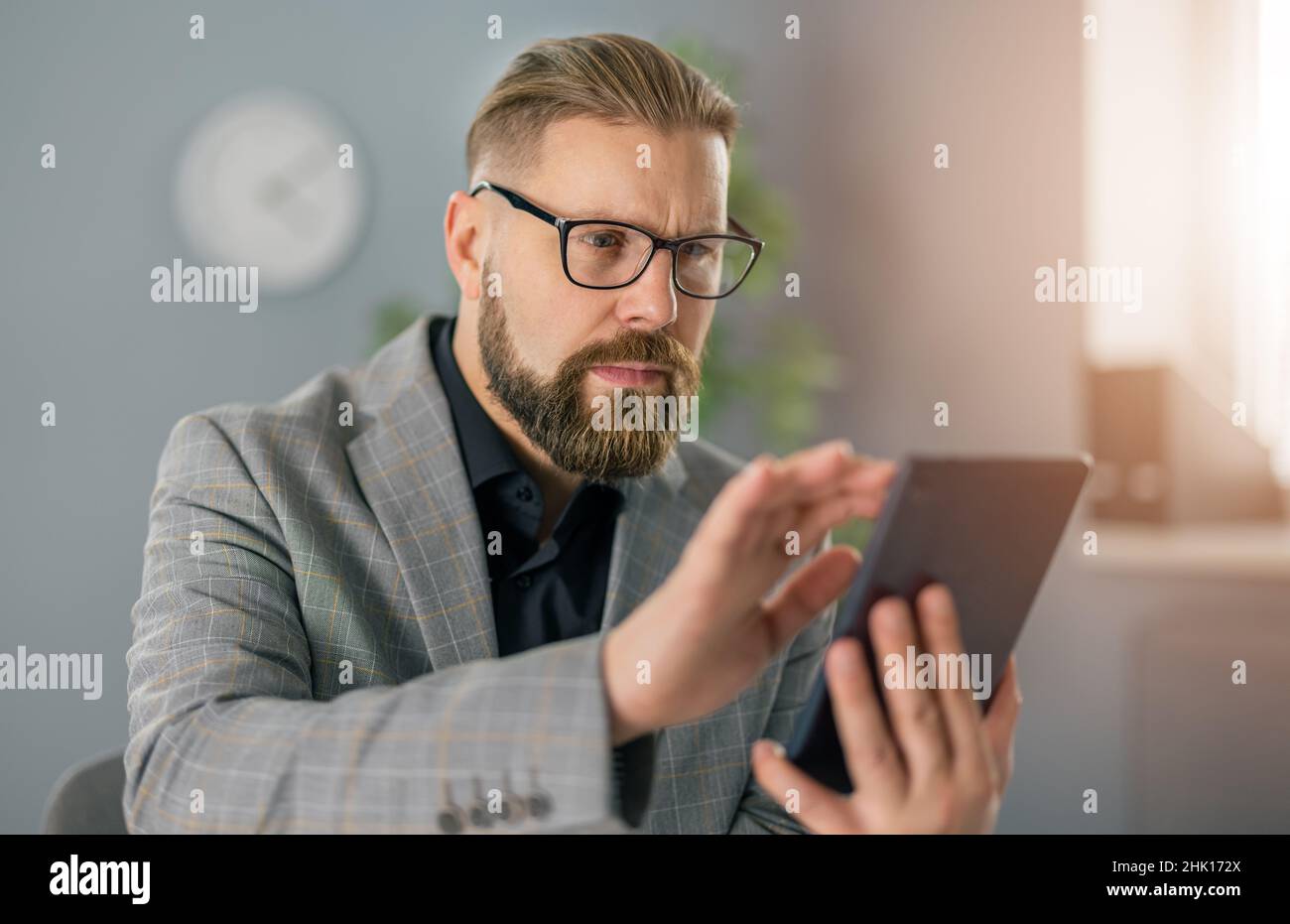 Businessman at office with tablet Stock Photo