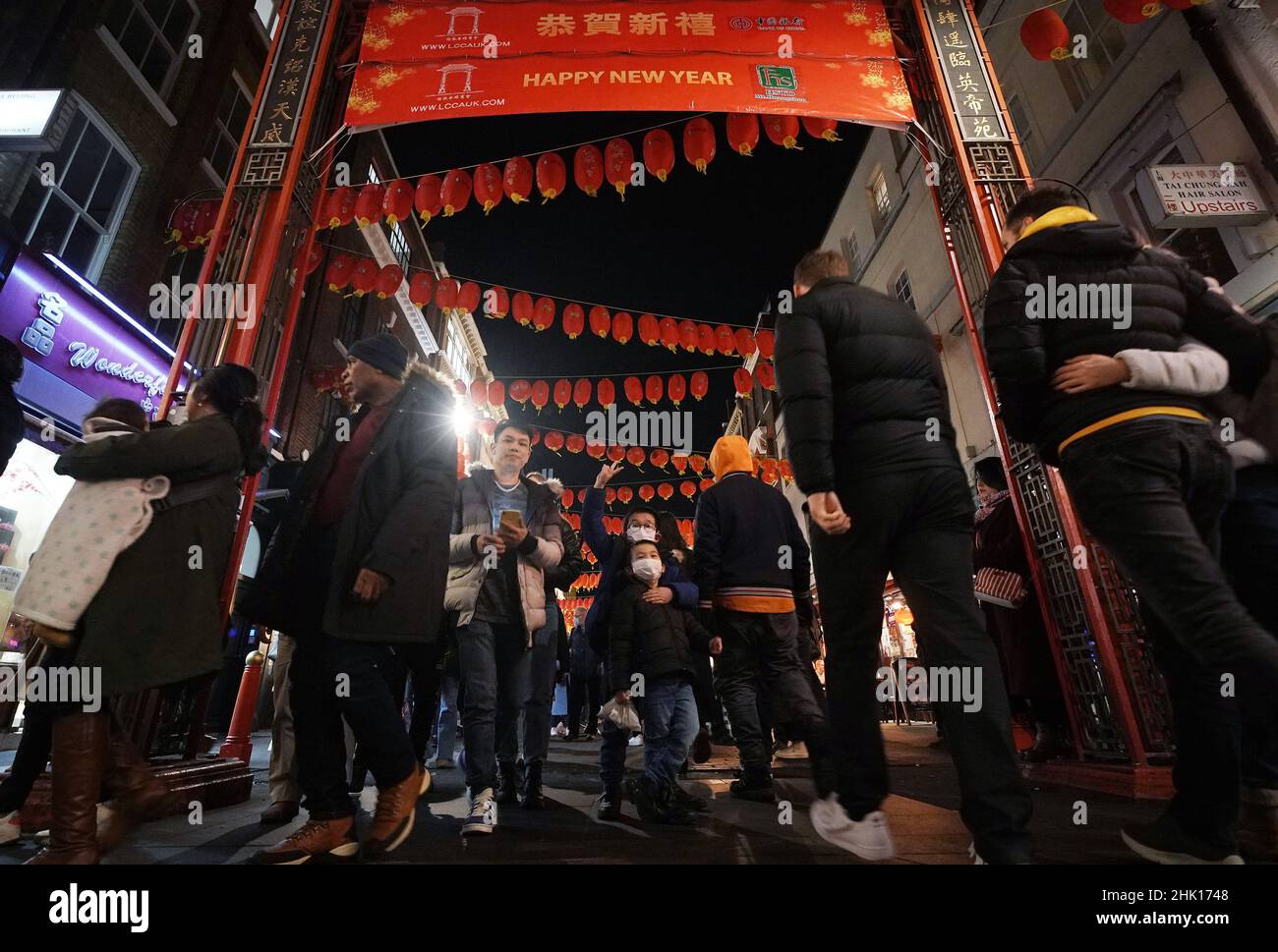 Children posing for a picture underneath one of the gates in Chinatown, London, celebrating the Lunar New Year. The Lunar New Year - beginning on February 1 - is the start of a two-week celebration and is the most important holiday for millions of people around the world. Picture date: Tuesday February 1, 2022. Stock Photo