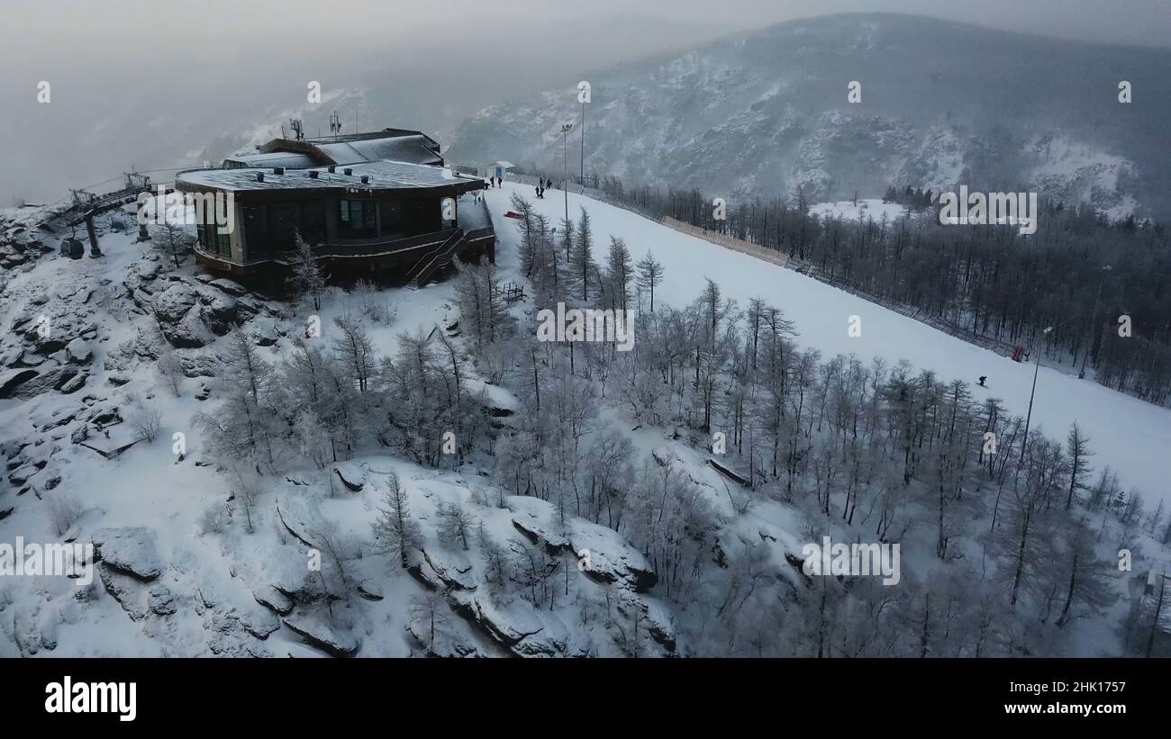 Aerial view of the ski resort with snowy mountain slopes and winter ...