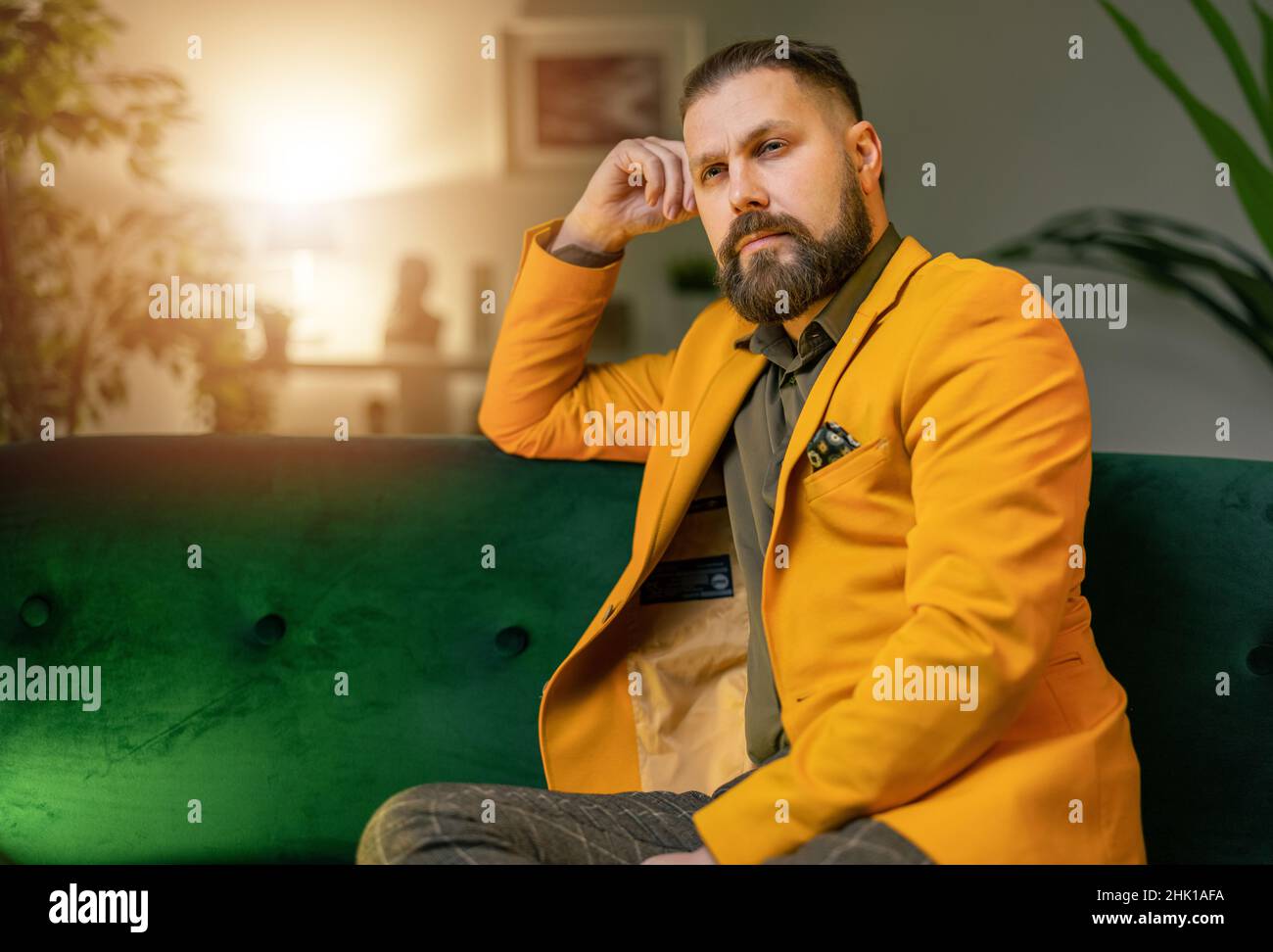 Pensive man on couch Stock Photo
