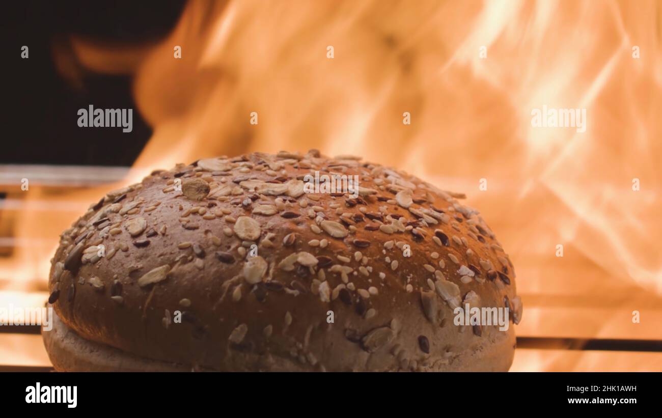 Loaf on grill. Stock footage. Grain bread for hamburgers is fried on