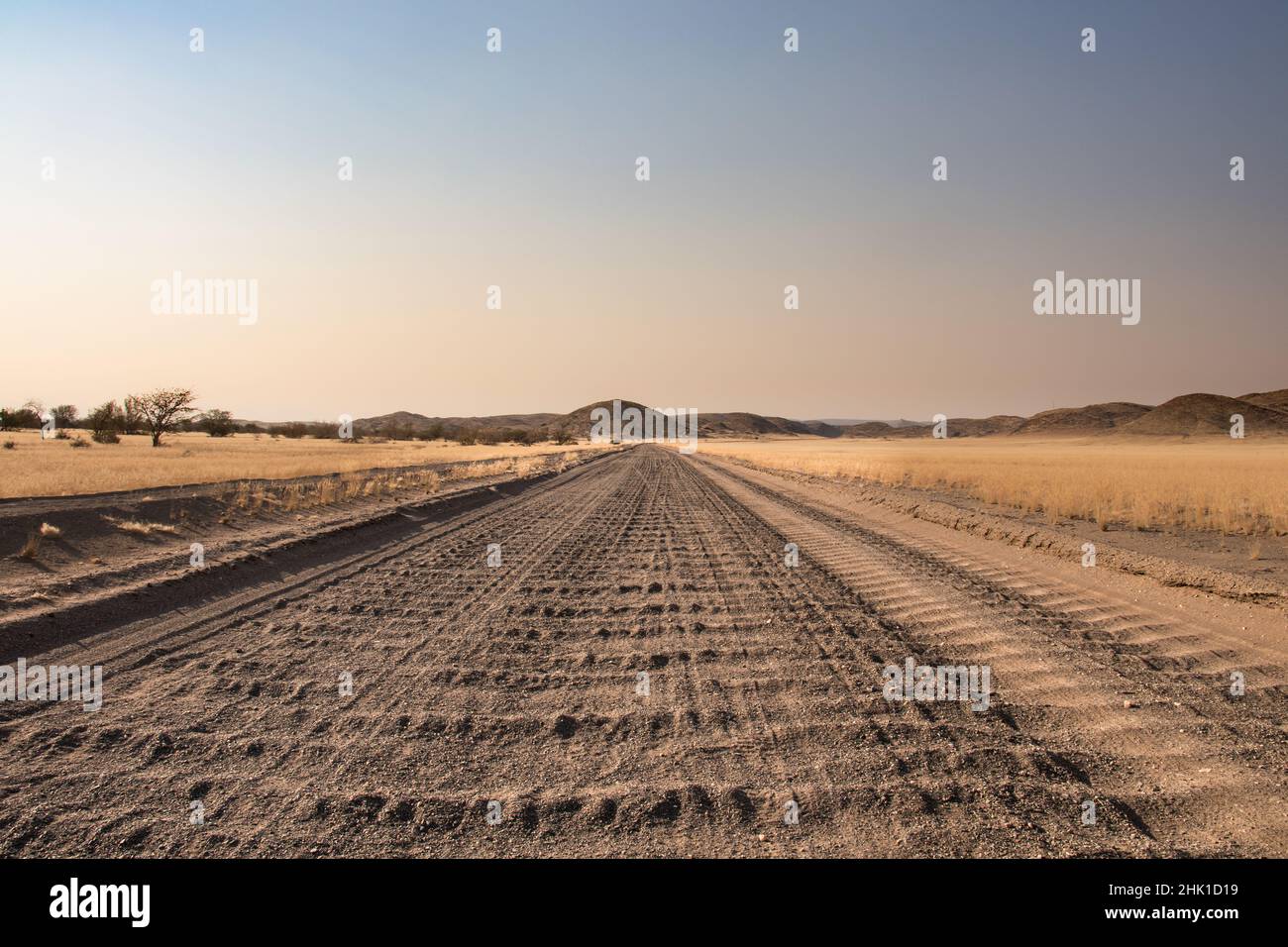 close up of a washboard gravel road and warning road sign in Namibia Stock Photo Alamy