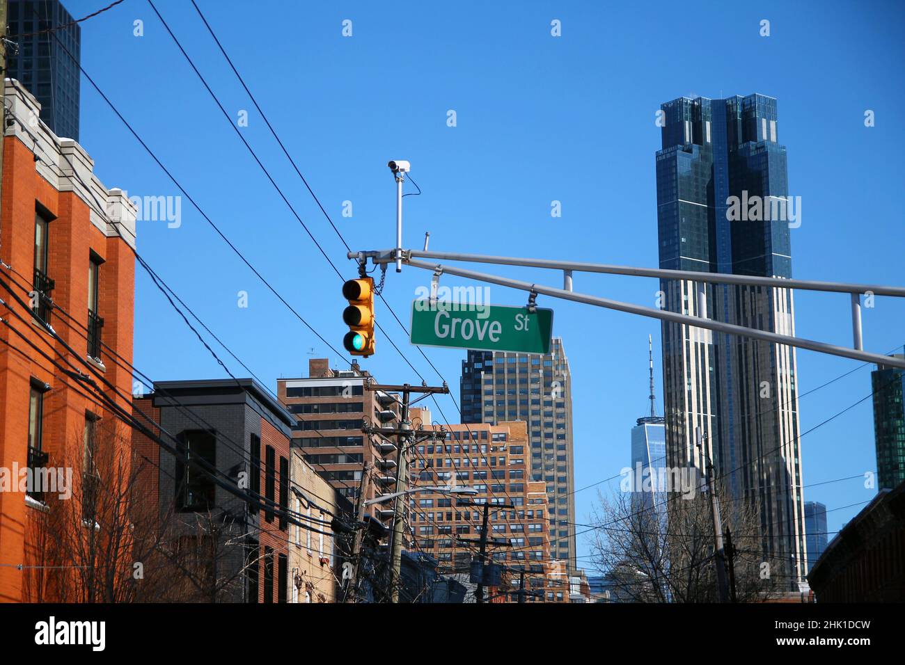 Green big Grove Street sign hanging on a arch pole between traffic lights in the streets of downtown Jersey City Stock Photo
