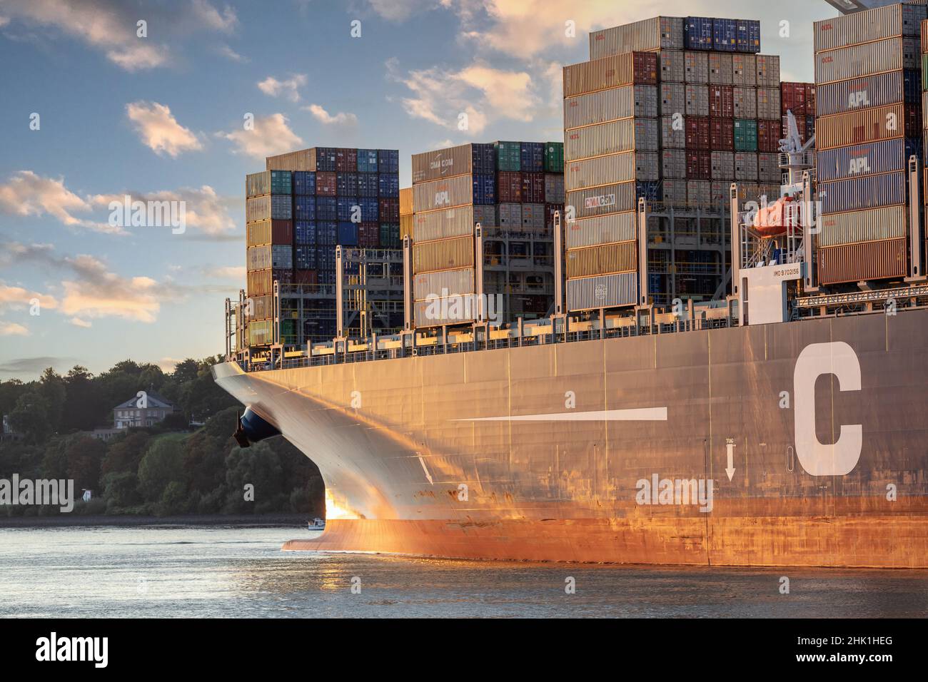 Large containership on river elbe in Hamburg Stock Photo