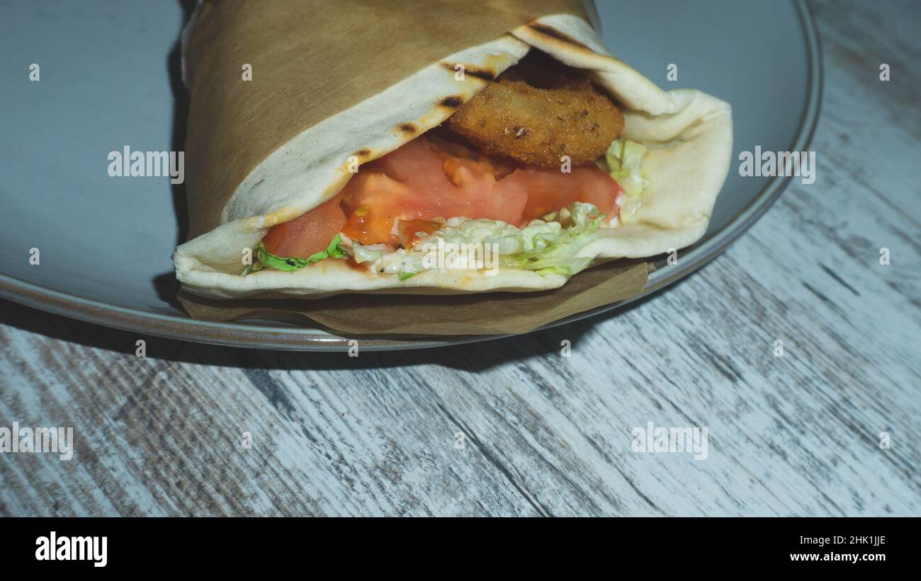 Chicken wrap on a plate. shawarma close up. traditional street food