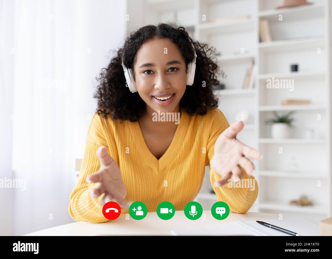 Portrait screen view of happy young black woman in headphones making ...