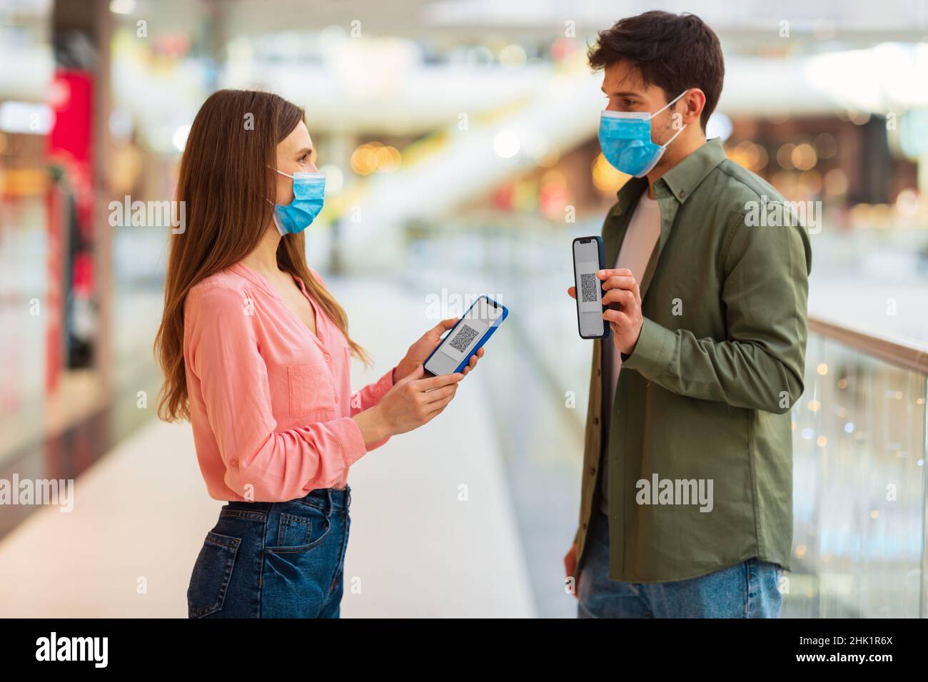 Couple Showing Smartphones With QR Codes Wearing Masks In Mall Stock ...