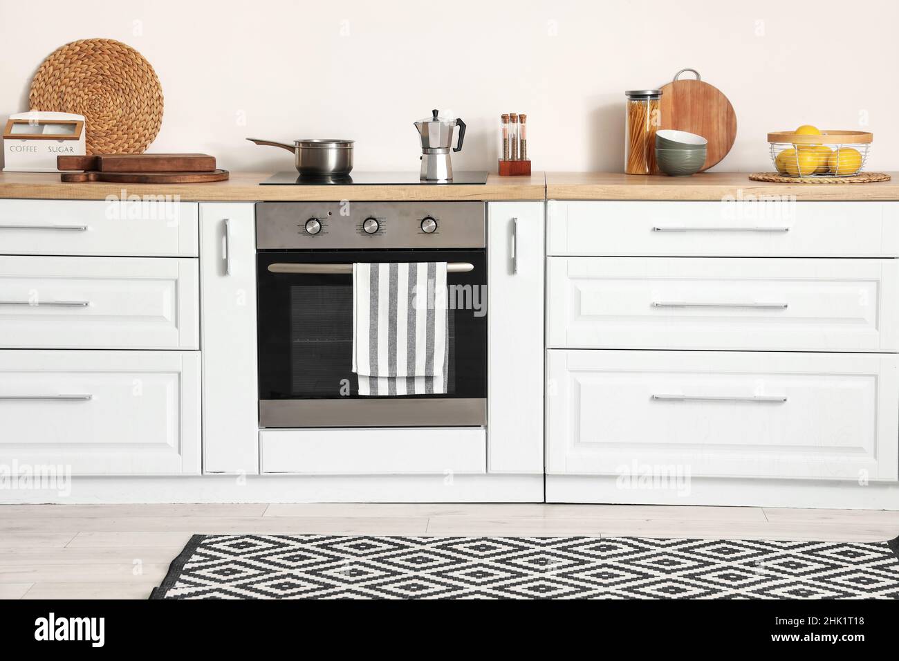 White kitchen counters and modern oven in room interior Stock Photo - Alamy