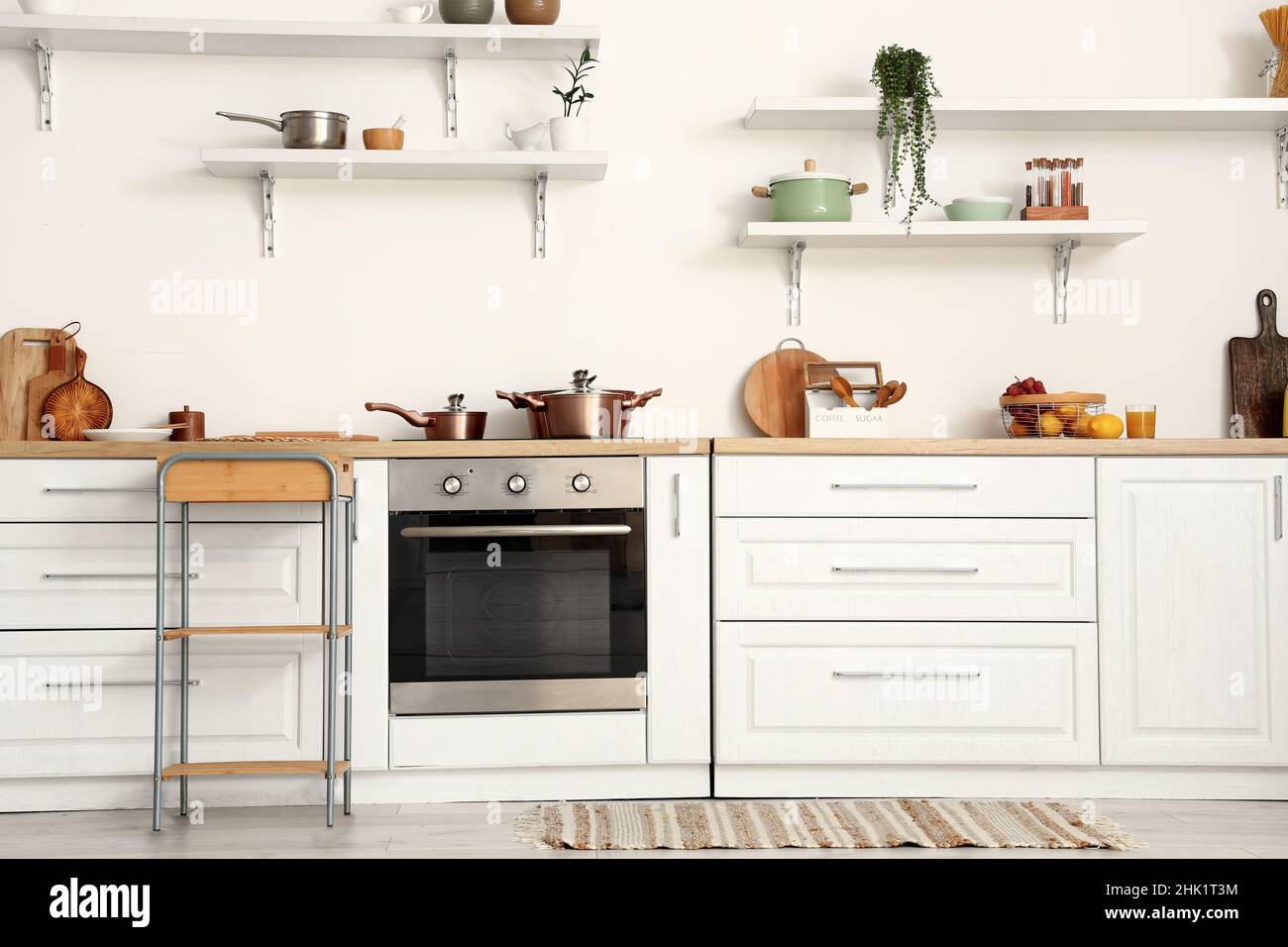 White counters and modern oven in kitchen interior Stock Photo - Alamy