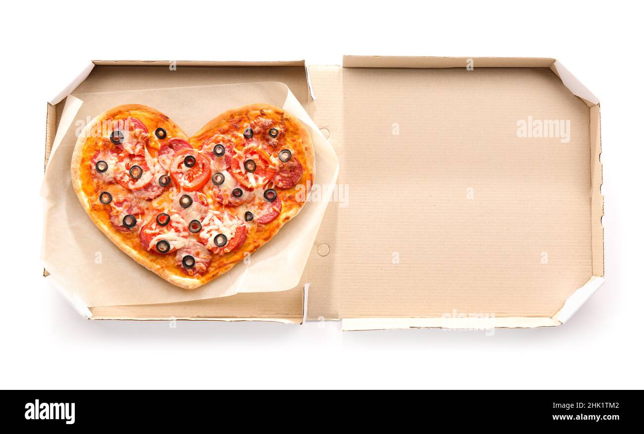 Cardboard box with tasty heart-shaped pizza on white background