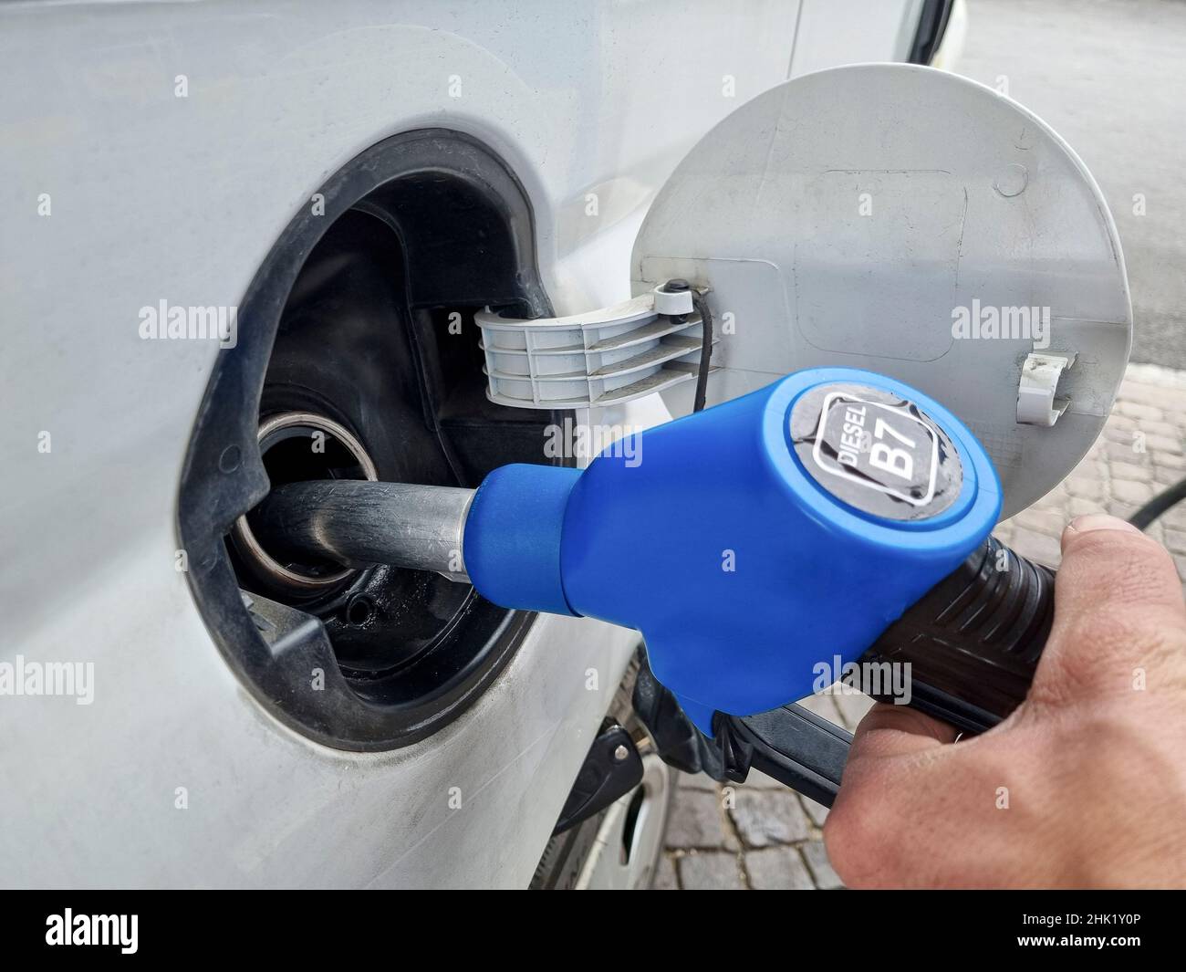 Man at Gas station while refueling a car,increasing petrol costs concept Stock Photo