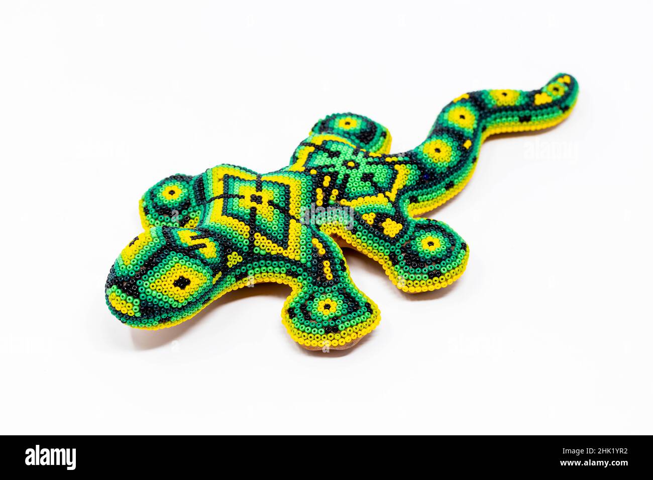 Beautiful huichol tradition pattern crafted lizard isolated Stock Photo