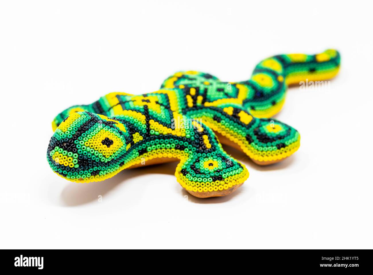 Beautiful huichol tradition pattern crafted lizard isolated Stock Photo