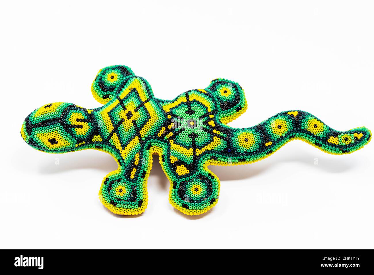 Beautiful huichol tradition pattern crafted lizard isolated Stock Photo