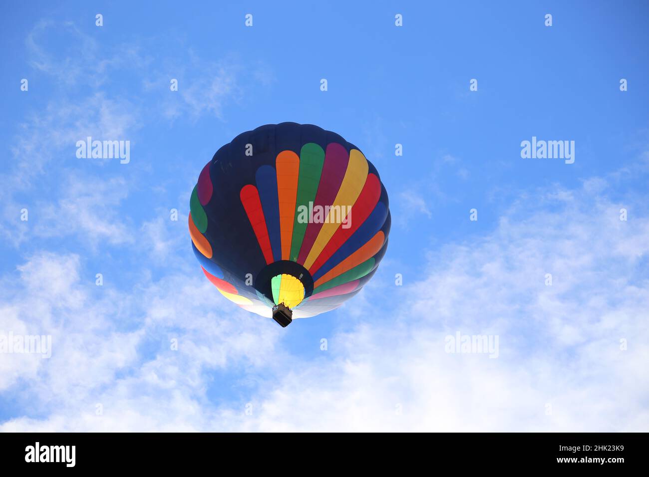Colorful hot air balloon in a clear blue sky Stock Photo - Alamy