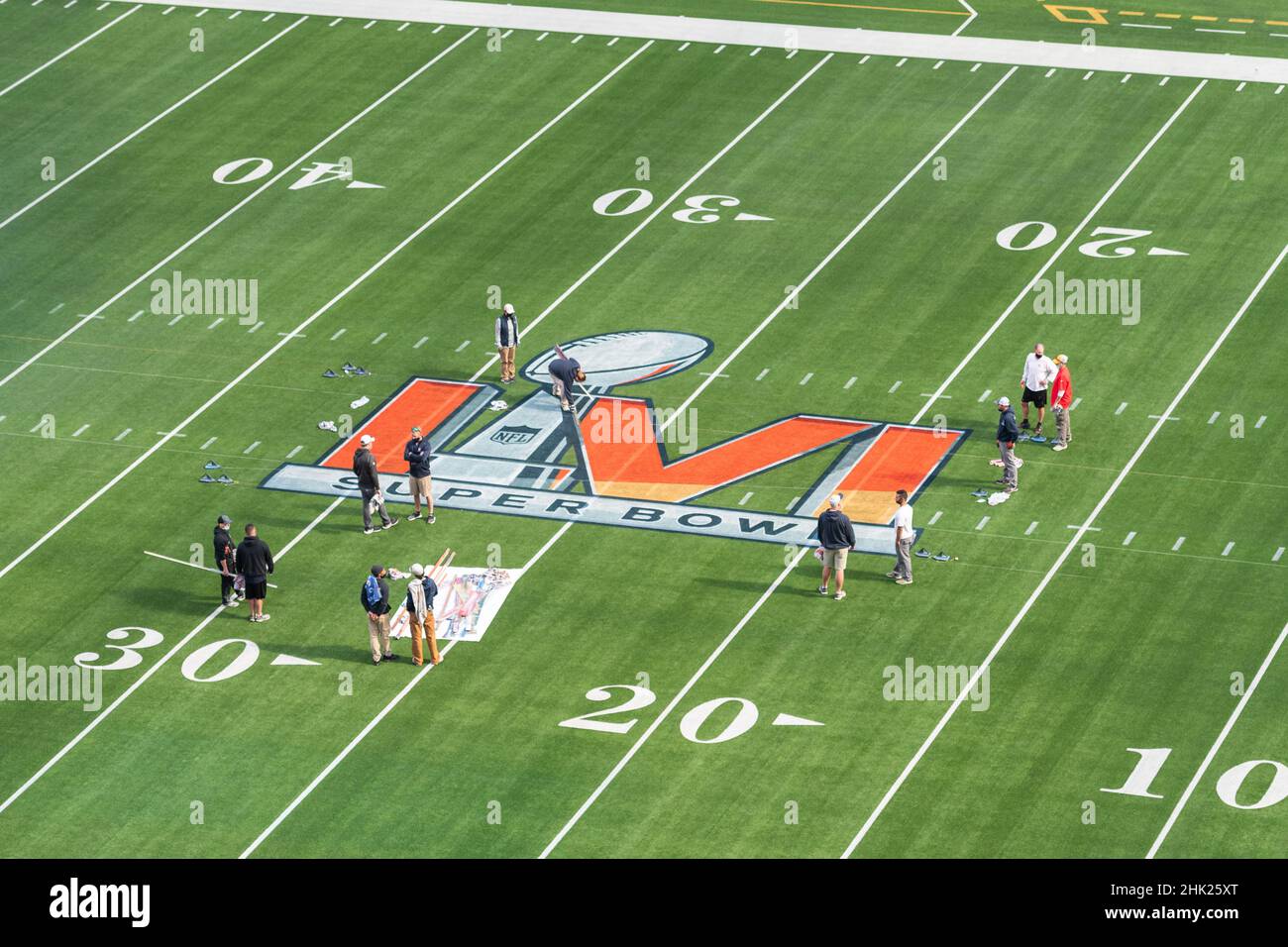 Inglewood, USA. 01st Feb, 2022. Workers paint the Super Bowl LVI logo on  the field at SoFi Stadium. The Los Angeles Rams and the Cincinnati Bengals  will meet here on February 13,