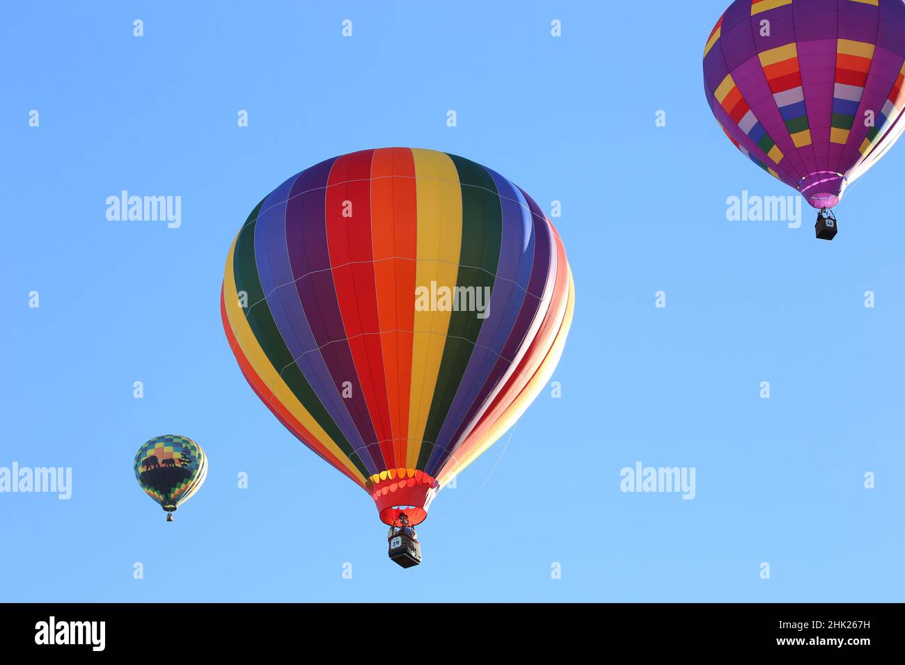 Colorful hot air balloons in a clear blue sky Stock Photo - Alamy