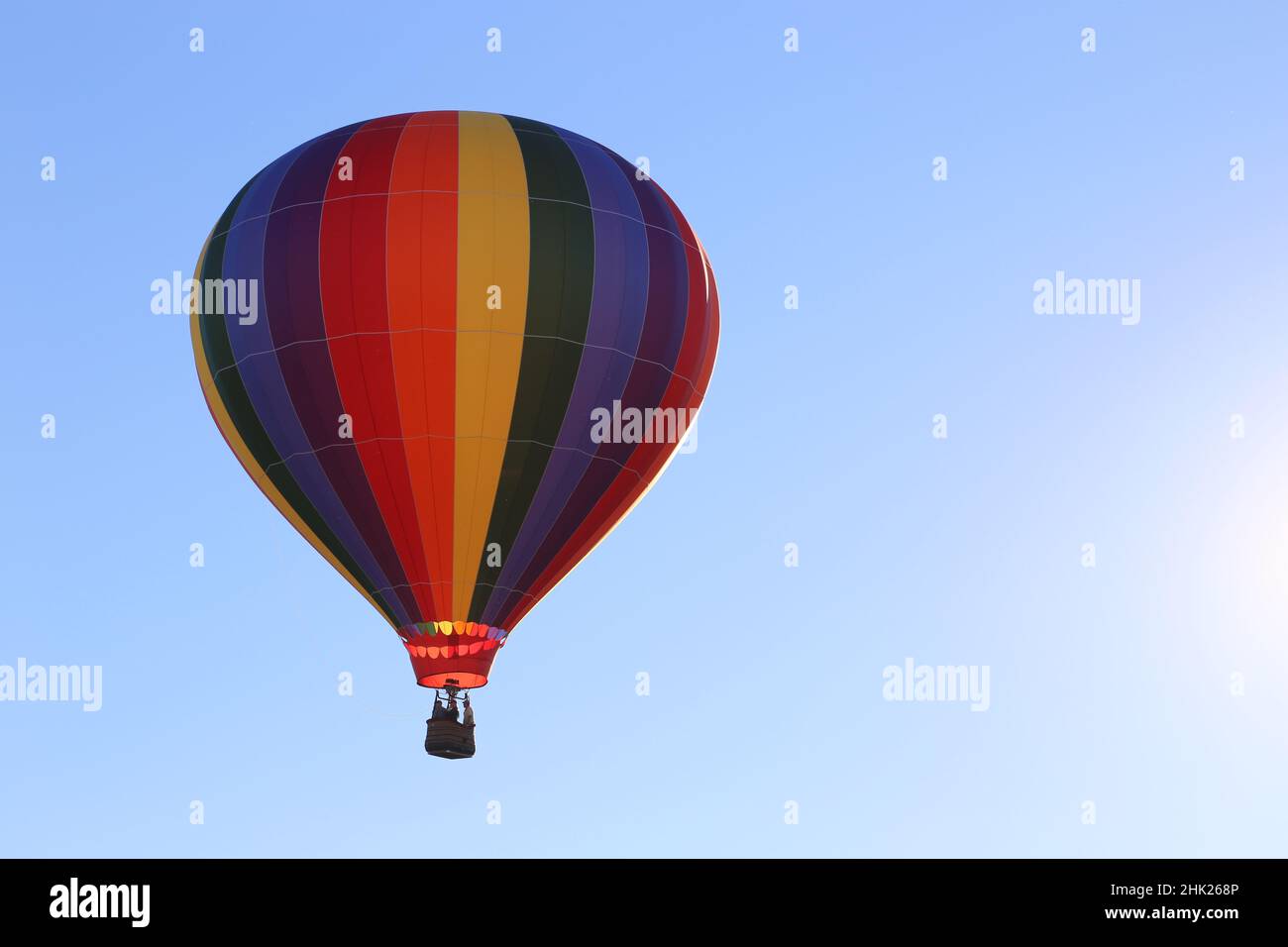 Colorful hot air balloon in a clear blue sky Stock Photo - Alamy