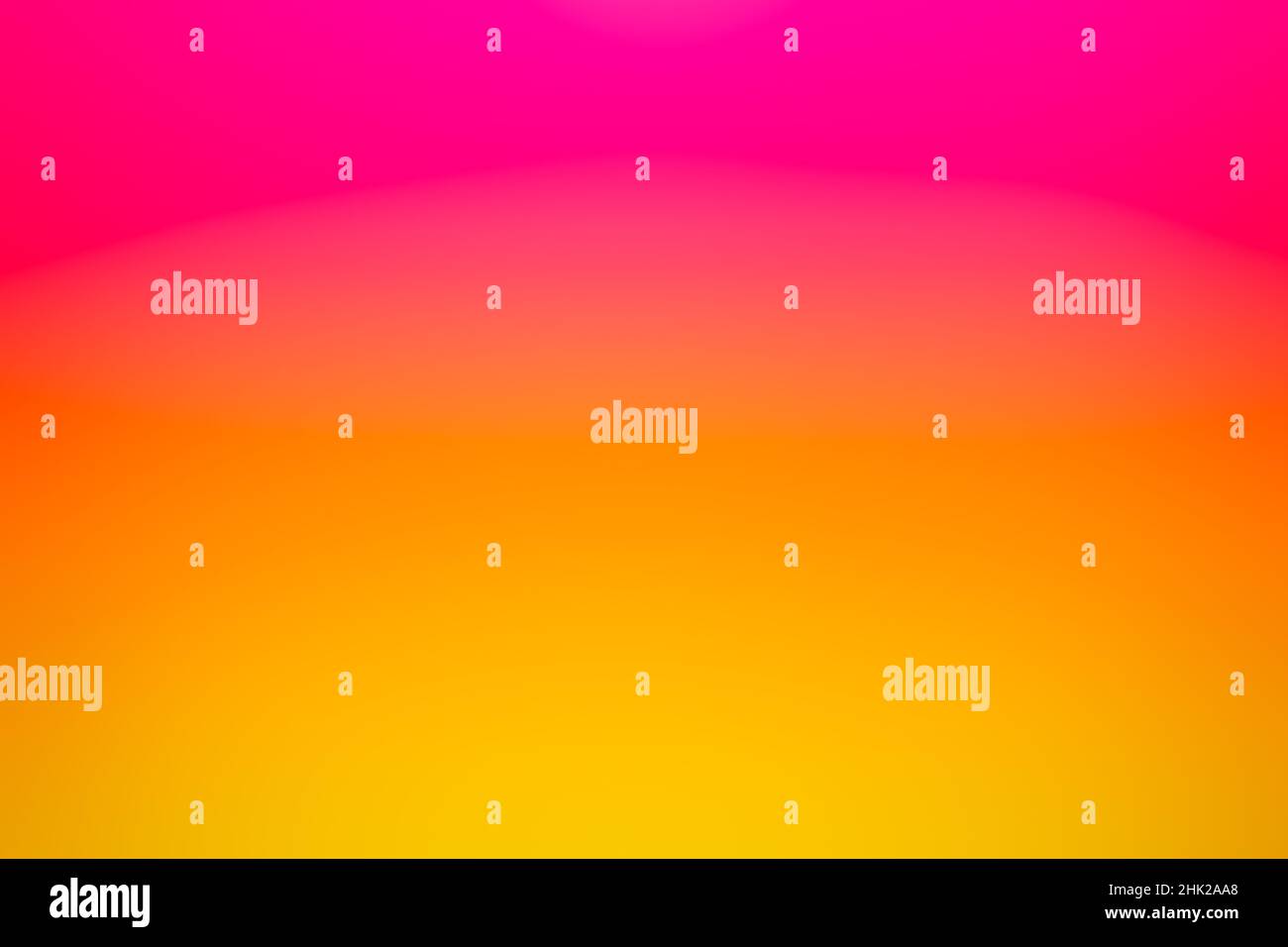 A colorful pink and golden yellow blurred sunset background gradient texture. Stock Photo