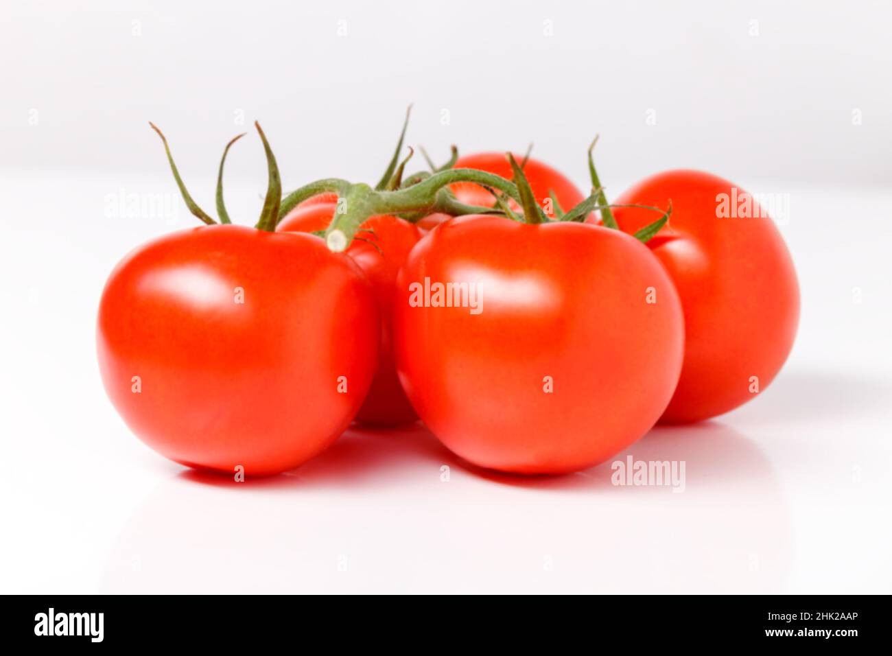 red tomatoes isolated on white background Stock Photo - Alamy